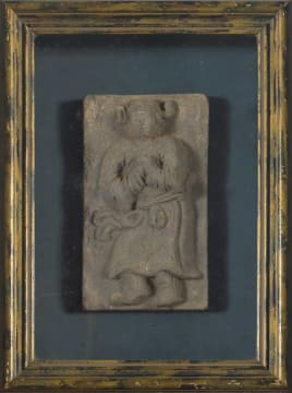 A Chinese figural unglazed pottery tile