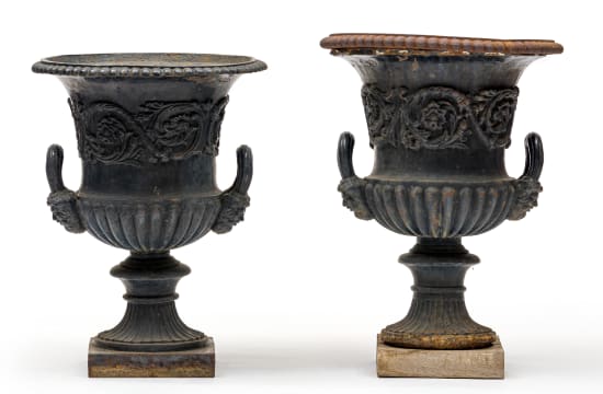 A pair of Victorian cast-iron black-painted urns