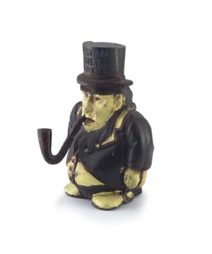 A Transvaal cast-iron and painted money box, 20th century