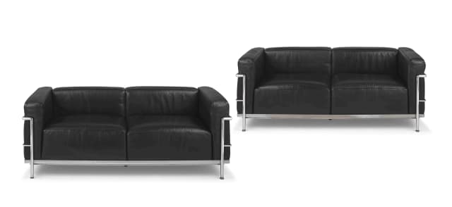 A pair of LC3 leather and chrome two-seater settees designed by Le Corbusier, Charlotte Perriand and Pierre Jeanneret, later edition