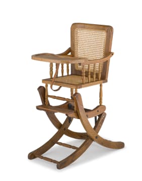 An Edwardian oak and caned high/rocking chair