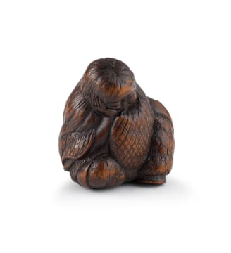 A Japanese wooden netsuke of a slumbering Shojo, Meiji period, 1868-1912