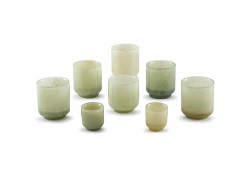 An assembled set of six Chinese celadon carved jade wine cups, Qing Dynasty, 19th century