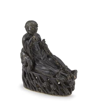 A Chinese black and dark olive green-glazed figure of a Luohan, Qing Dynasty, late 19th century