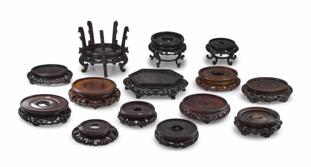 A collection of fourteen Chinese hardwood stands, Qing Dynasty, late 19th century