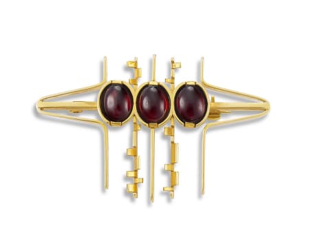 Erich Frey; Three stone cabochon-cut garnet and gold brooch, Erich Frey, (1917-2004)