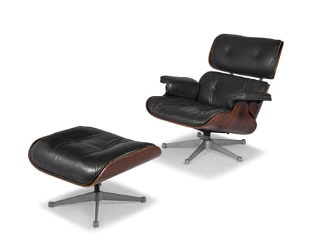 A leather and rosewood-veneered model 670 lounge chair and 671 ottoman released in 1956 for Herman Miller by Charles and Ray Eames, 1950s