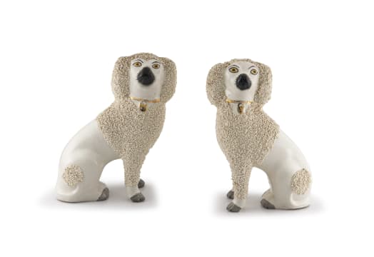 A pair of Staffordshire figures of poodles