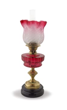 A brass mounted cranberry glass oil lamp