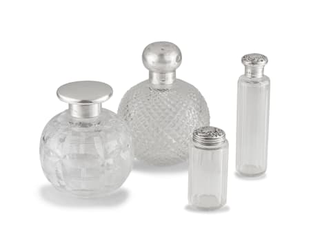 Four silver-mounted cut-glass toiletry bottles