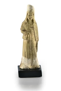 A Chinese pottery figure of a tomb attendant, T'ang dynasty, 618 - 906