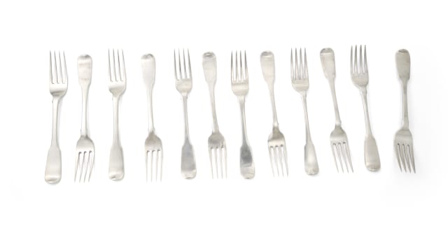 An assembled set of George III fiddle pattern Irish silver cake forks, James Le Bas, Dublin,1827; and various makers