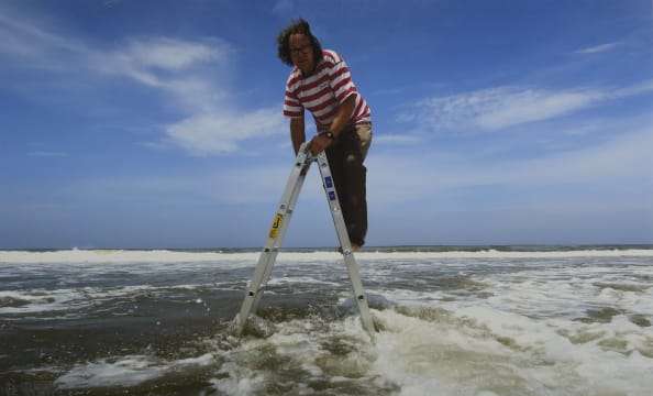 Jacques Coetzer; One Meter above Mean Sea Level, Artist Jacques Coetzer Suspended over the Warm Waters of Durban, South Africa, December 2, 2011