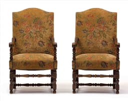 A pair of walnut and upholstered armchairs