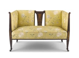 An Art Nouveau inlaid mahogany and upholstered two-seater settee