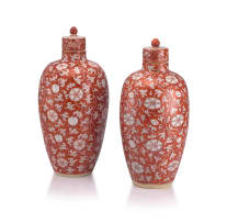 A pair of Chinese iron-red-glazed vases and covers, Qing Dynasty, Kangxi period, 1662-1722