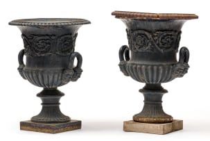 A pair of Victorian cast-iron black-painted urns