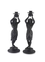A pair of patinated bronze candlesticks, early 20th century