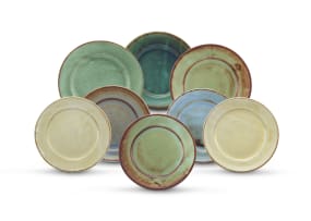An assembled set of eight Linn Ware glazed bread plates