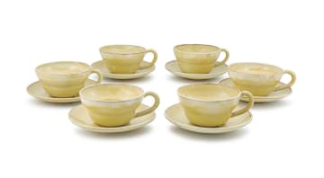 A set of six Linn Ware yellow-glazed breakfast cups and saucers