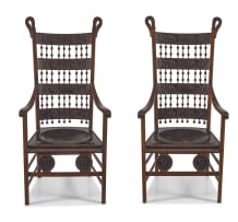 A pair of Arts and Crafts beech and leather armchairs