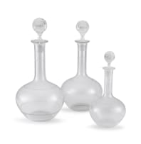 Three clear glass and engraved decanters and stoppers