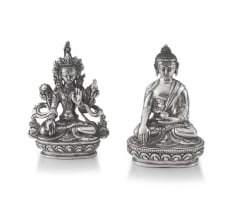 A silver figure of Buddha