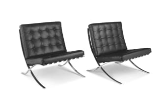 A pair of black leather and chrome Barcelona chairs designed in 1929 by Ludwig Mies van der Rohe, later edition