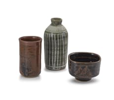 Brown stone cylinder vase, brown bowl and a bottle vase