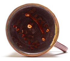 A Linn Ware cream and rust-glazed tankard