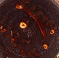 A Linn Ware cream and rust-glazed tankard