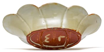 A Linn Ware yellow and russet-glazed scalloped dish