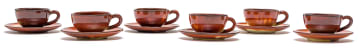 A set of six Linn Ware glazed demi-tasse cups and saucers
