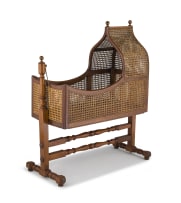 An Edwardian mahogany, teak and caned cradle, and later