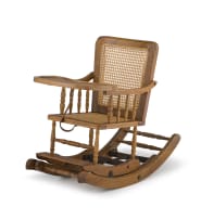 An Edwardian oak and caned high/rocking chair