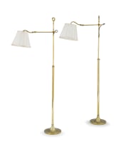 A pair of brass adjustable standing lamps