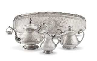 A Dutch silver teapot, tea strainer and covered sugar bowl, J.M. van Kempen & maker's initials VB, Schoonhoven, 1875, .950 standard