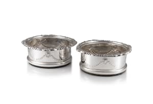 A pair of Edwardian silver-plate wine coasters