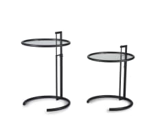 A pair of black lacquered E1027 tables after a design by Eileen Grey