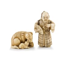 A Japanese ivory netsuke of a dog and her pups, Meiji period, 1868-1912
