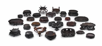 A collection of twenty-six Chinese hardwood stands, Qing Dynasty, 19th century