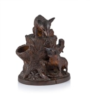 A Black Forest stained and carved linden wood smoker's compendium, 19th century