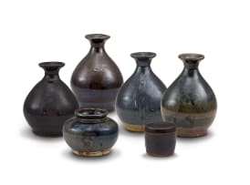 Four South East Asian mirror-black and brown glazed bottle vases, 17th/18th century