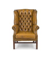 A George III style mahogany and leather upholstered wingback armchair