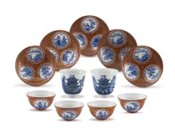 A part set of four Japanese blue and white and iron-red egg-shell porcelain tea bowls and five saucers, Meiji period, 1868-1912