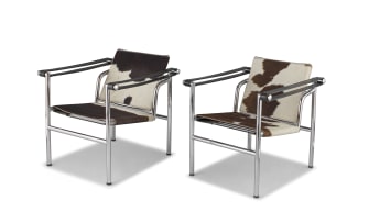 A pair of LC1 cowhide, leather and chrome armchair after a design by Le Corbusier, Pierre Jeannert and Charlotte Periand