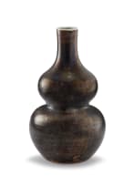 A Chinese mottled brown and mirror-black glazed double gourd vase, Qing Dynasty, 18th century