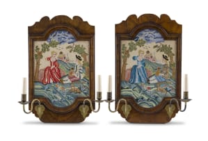 A pair of George II style walnut and embroidered sconces