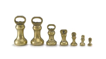 Seven brass bell-shaped balance weights, various makers