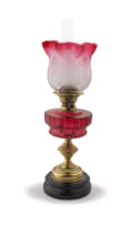 A brass mounted cranberry glass oil lamp